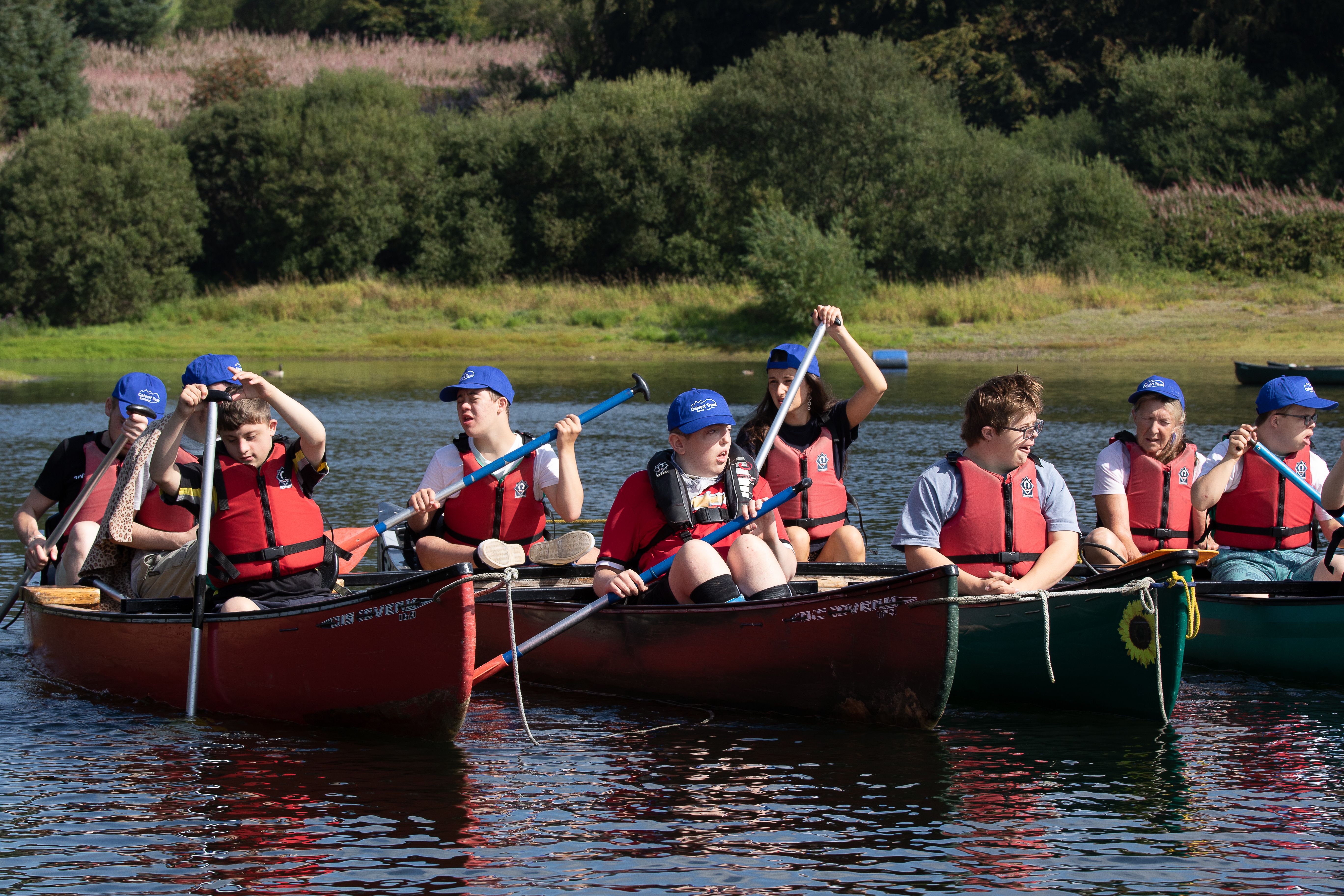 A group of Calvert Exmoor guests kayaking in the reservoir