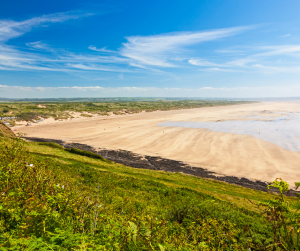A view of Saunton beach from the side of a hill with the sands stretching in the background