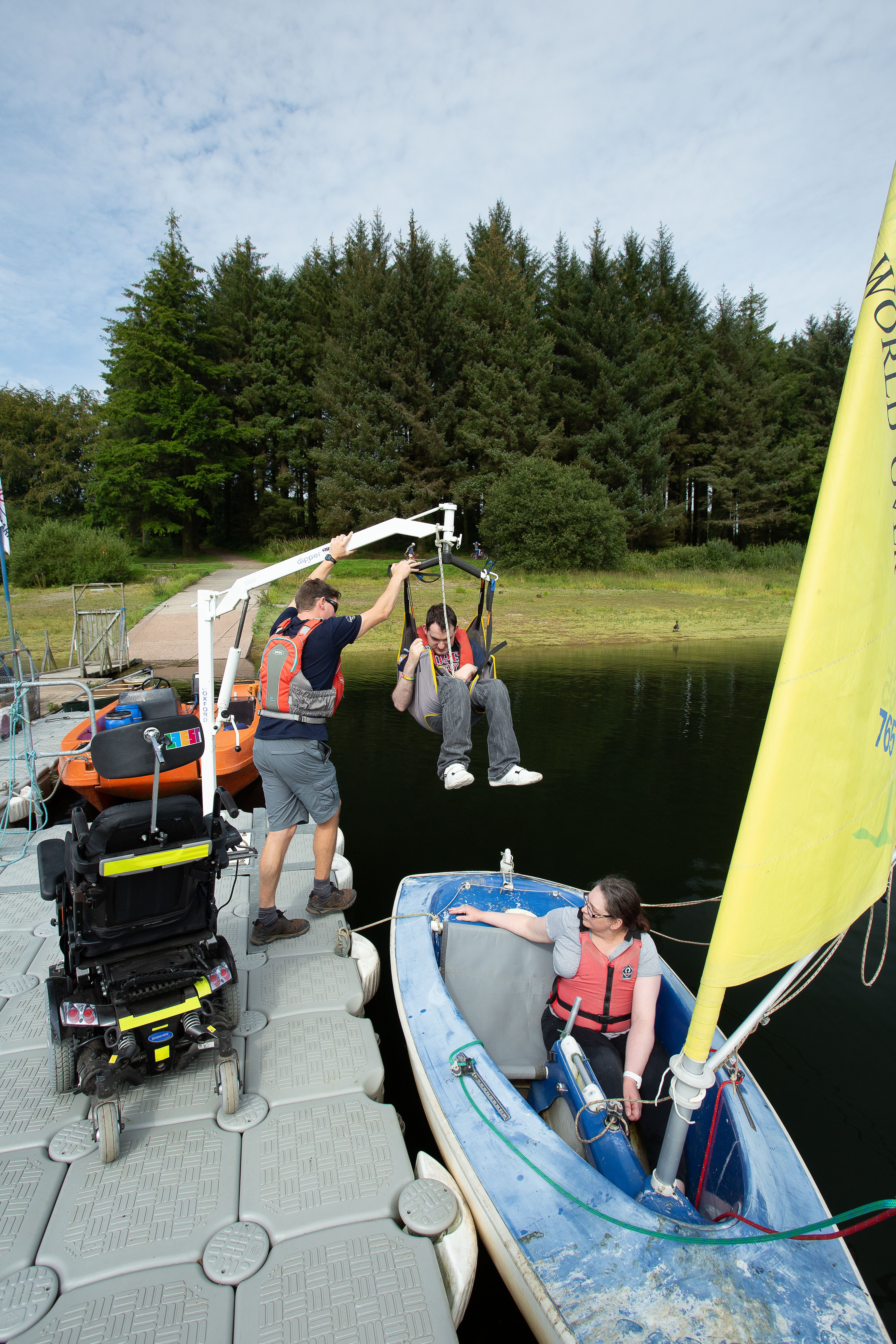 A Calvert Trust guest being hoisted into a boat 