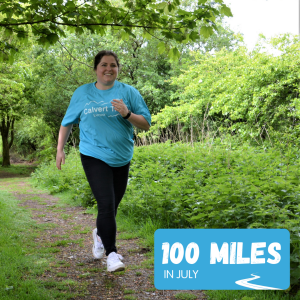 Lady running in a blue t-shirt through woodland
