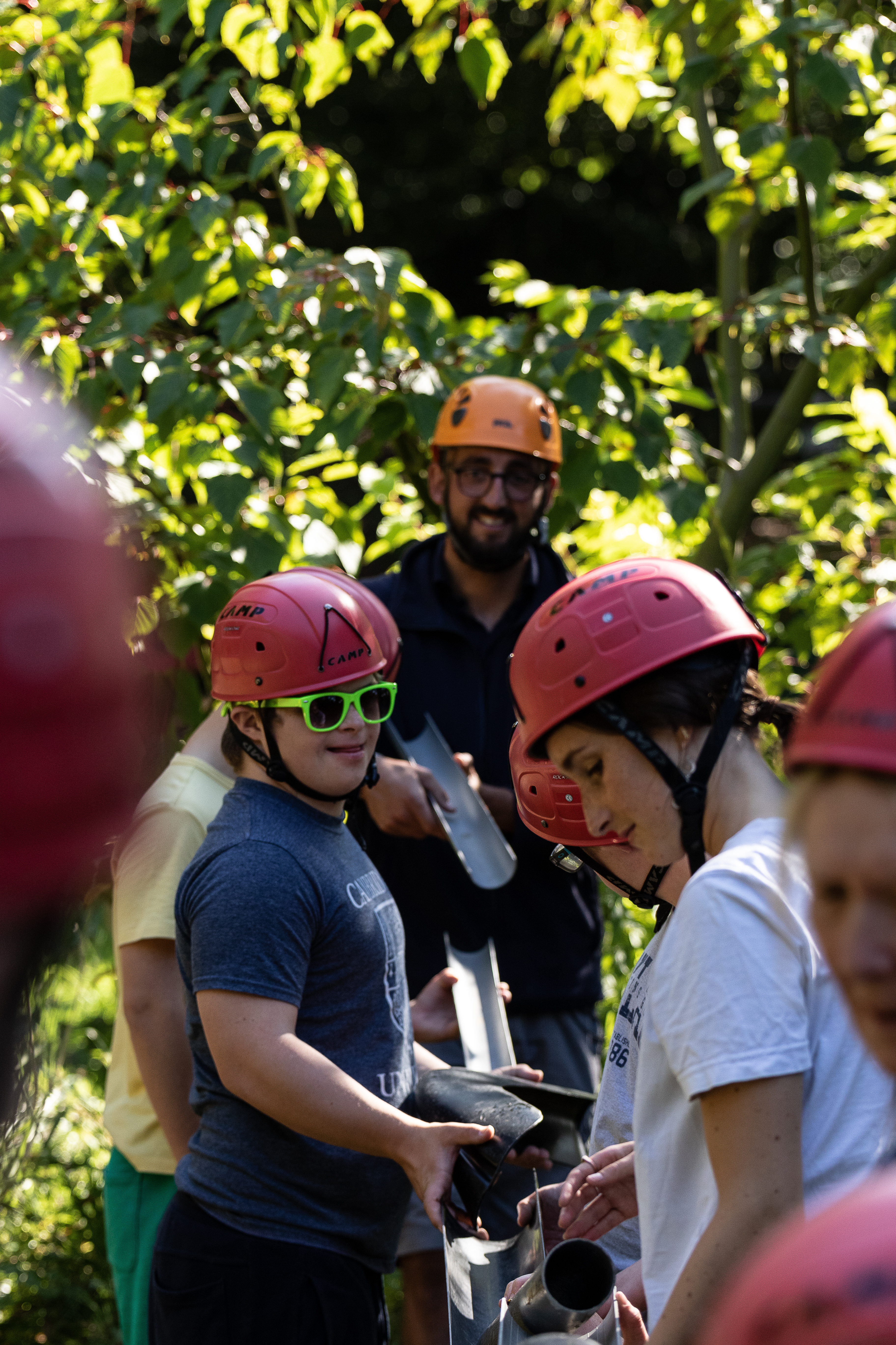 A group of Calvert Exmoor guests on the challenge course, wearing helmets