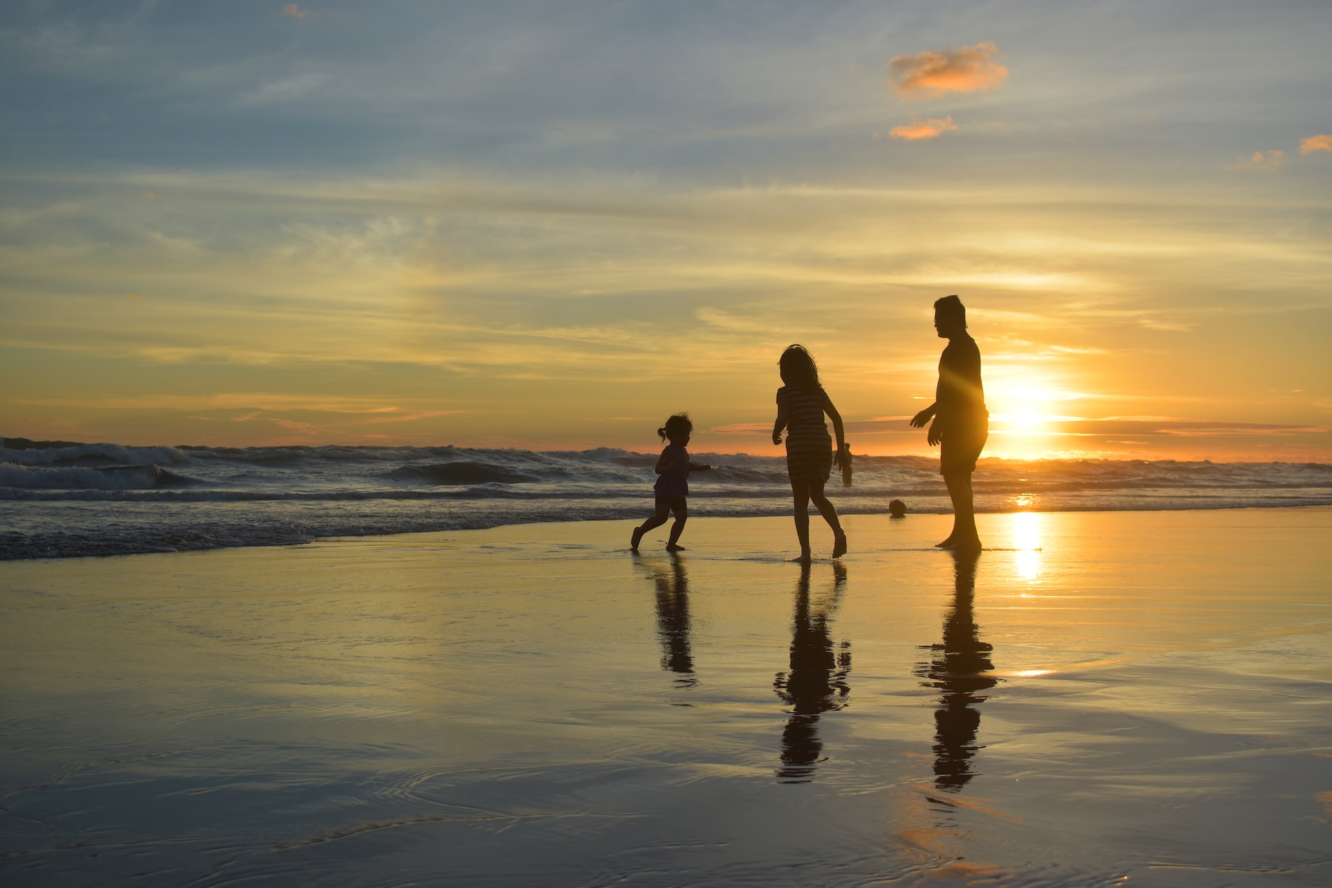 A family on the beach at sunset 