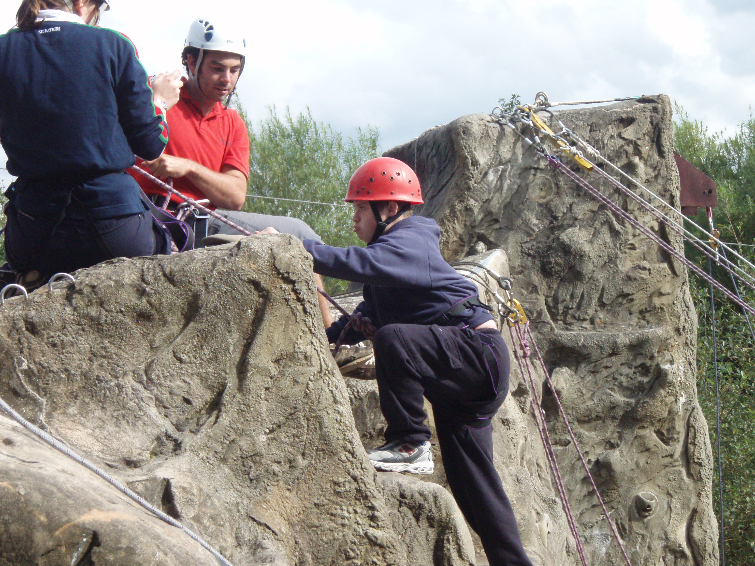 Guests on the outdoor climbing wall at Calvert Exmoor 