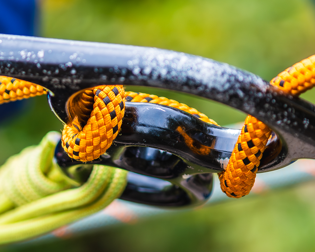 A close-up of yellow and green rope tied through a piece of metalwork for accessible abseiling at Calvert Exmoor.