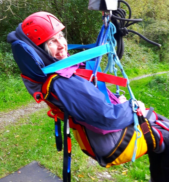 Guest Natalie is in her supportive sling attached into the Zipwire system, smiling at the camera and ready to go