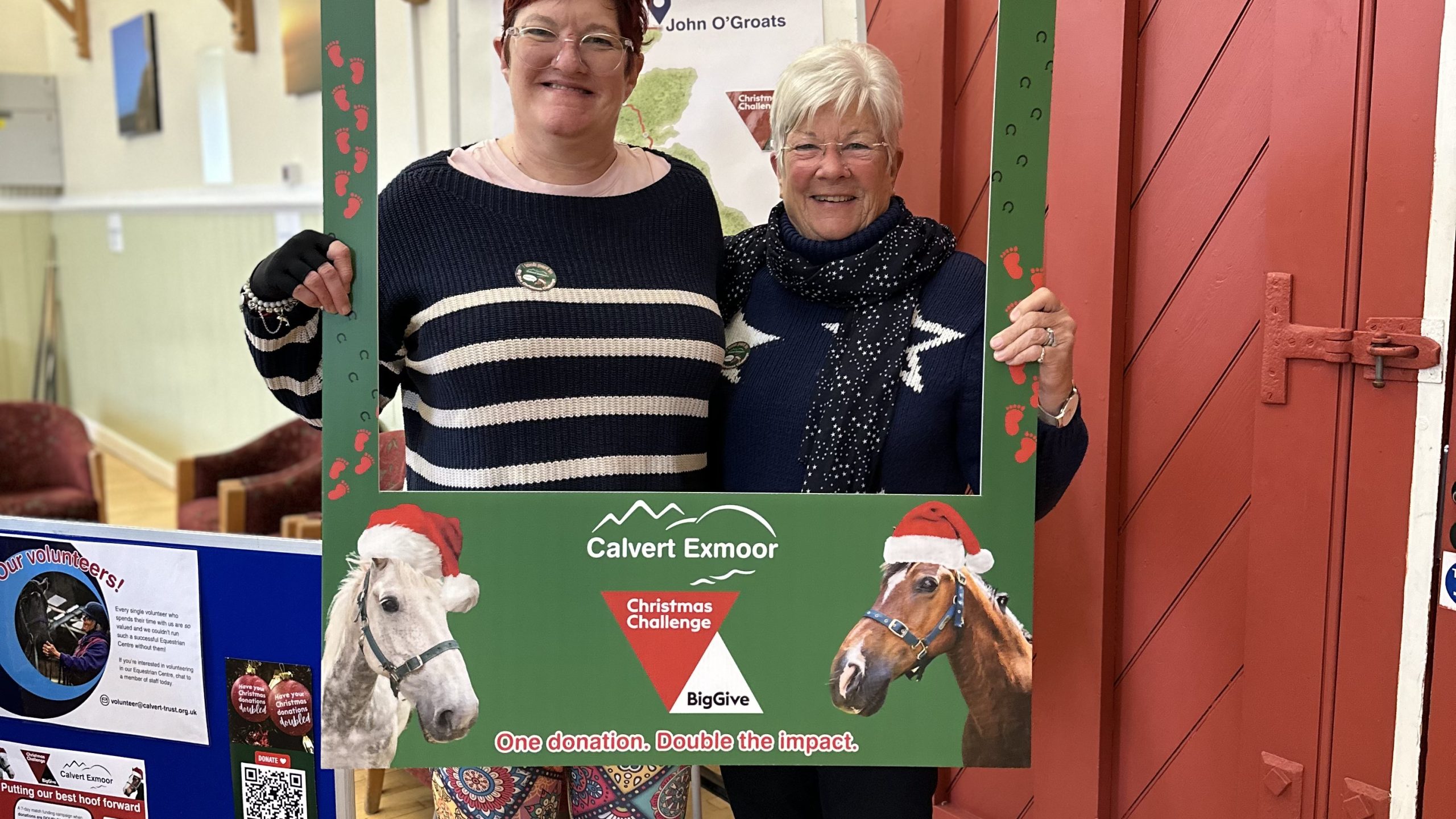 Sarah and Jan posing for the camera with a green phot frame