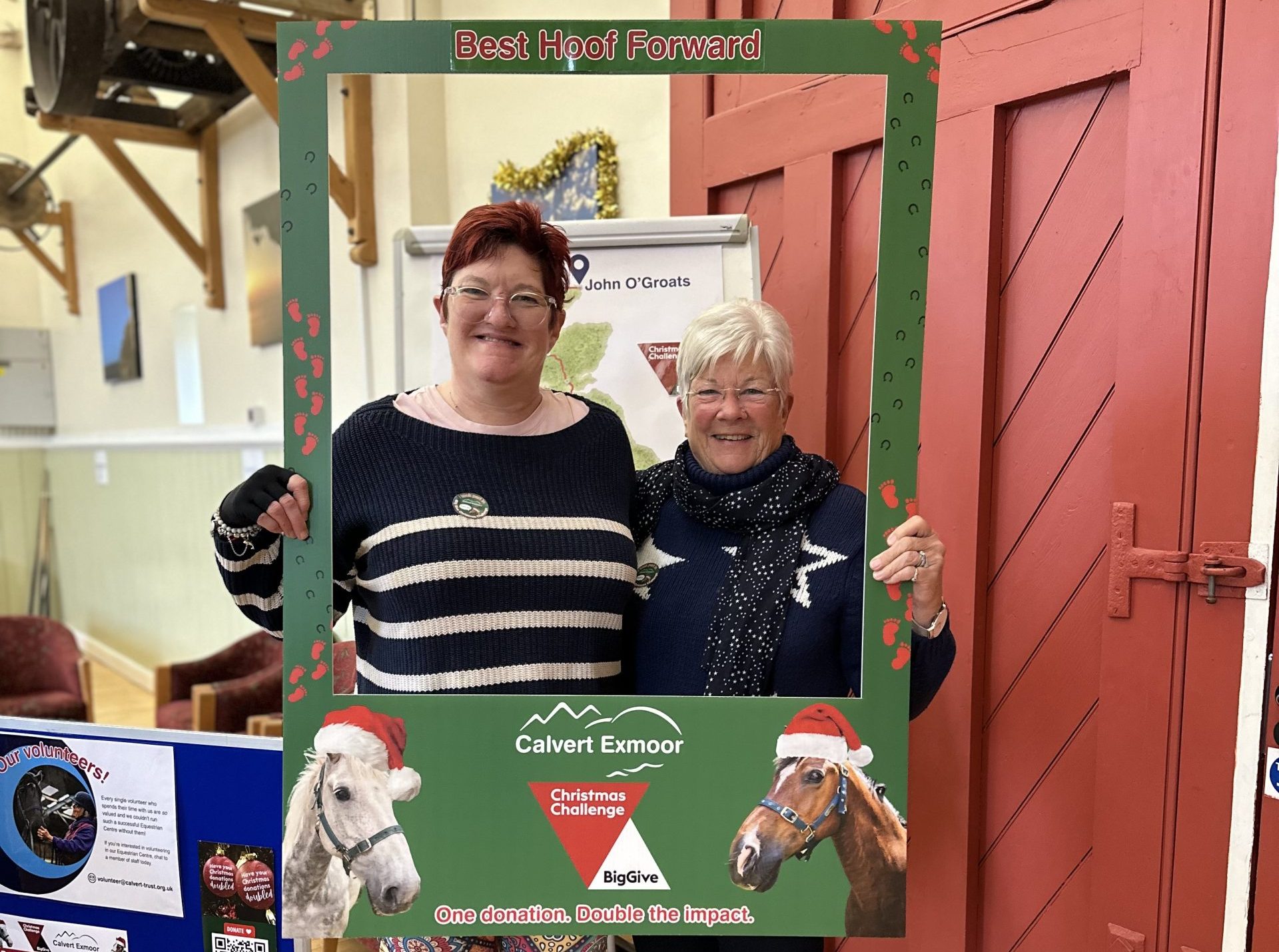 Sarah and Jan posing for the camera with a green phot frame